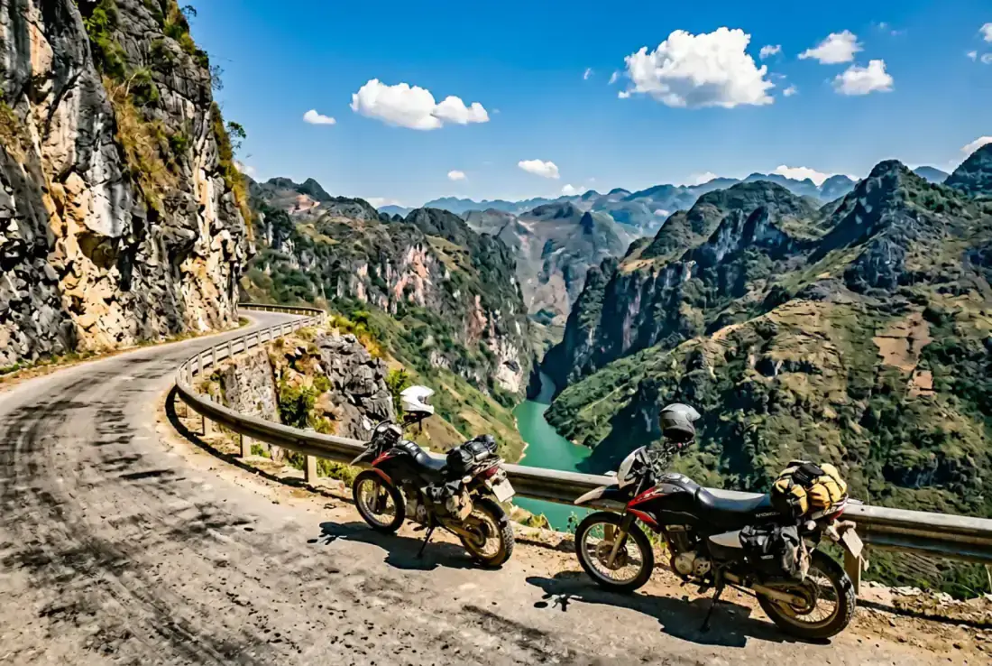 Riders on Ma Pi Leng Pass at sunrise above Nho Que river